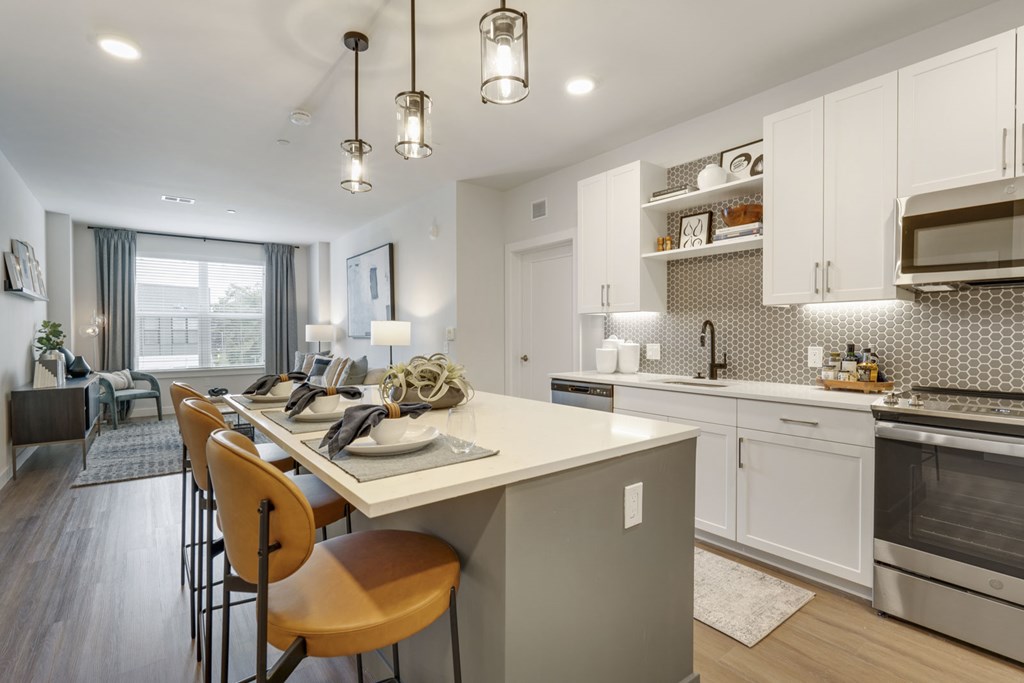 A modern kitchen with a dining table and chairs.