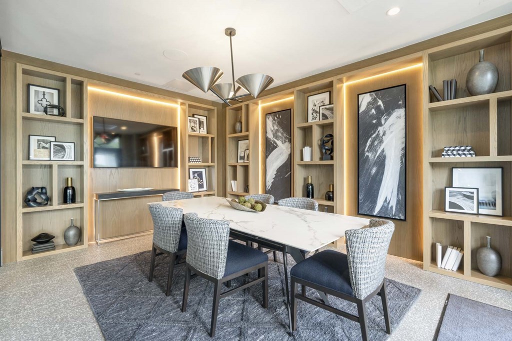 A dining room with a table set for four.