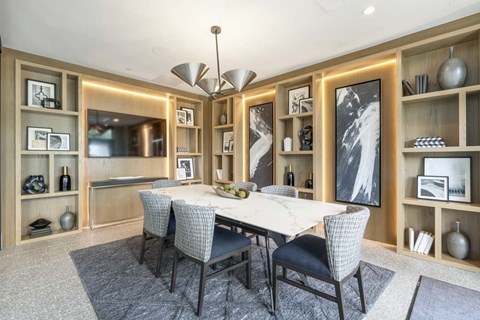 A dining room with a table set for four.