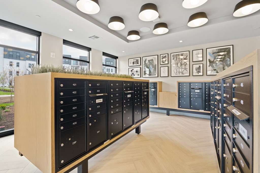 A long row of mailboxes are lined up on a wall.