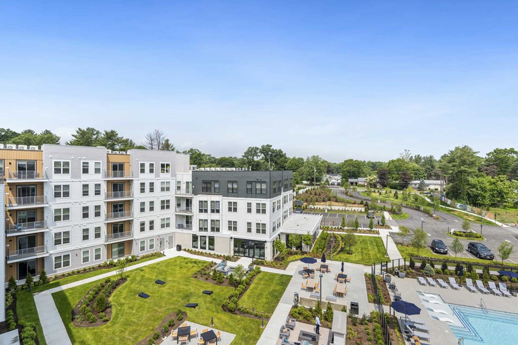 A large apartment complex with a pool and landscaped grounds.