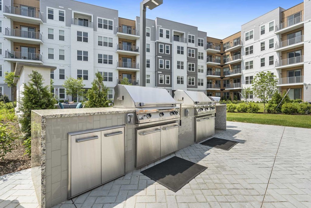 A modern apartment complex with a concrete structure in the foreground.