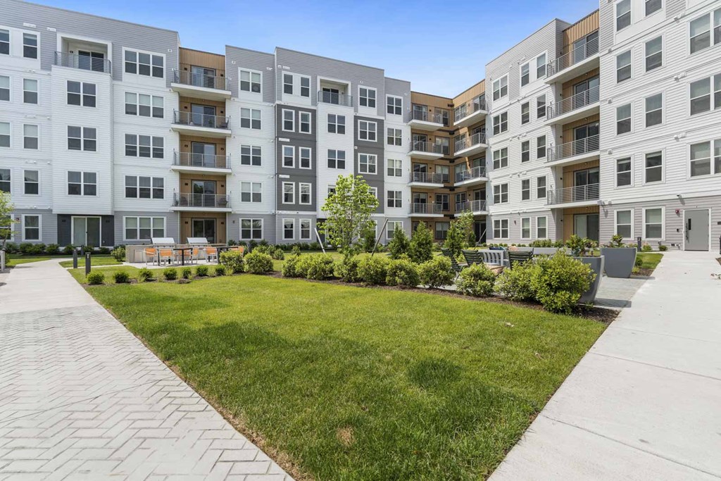 Apartment complex with a green lawn in front.