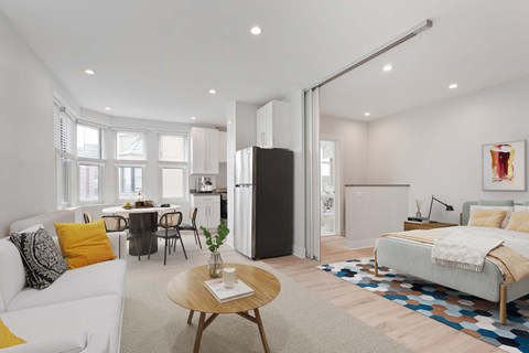 A modern living room with a white sofa and a wooden coffee table.