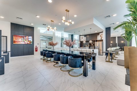 A modern dining room with a long table and chairs.