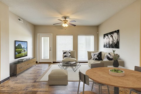 A living room with a wooden table and chairs.