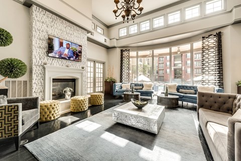 A living room with a fireplace and a television mounted on the wall.