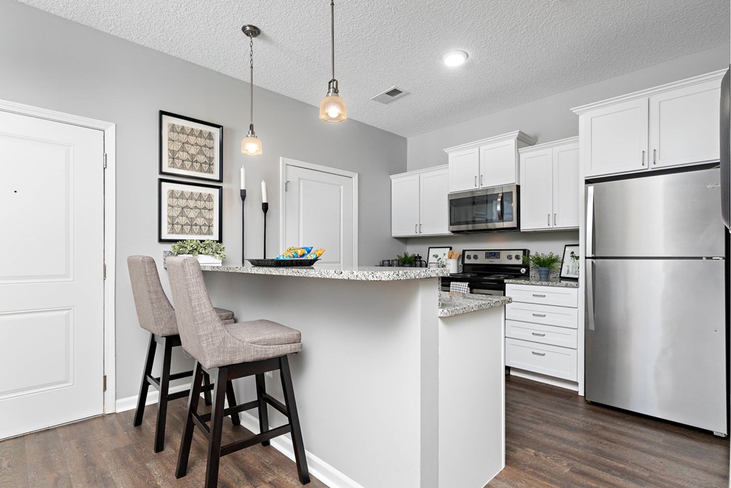 A1- Kitchen A kitchen with a white counter and stainless steel appliances.