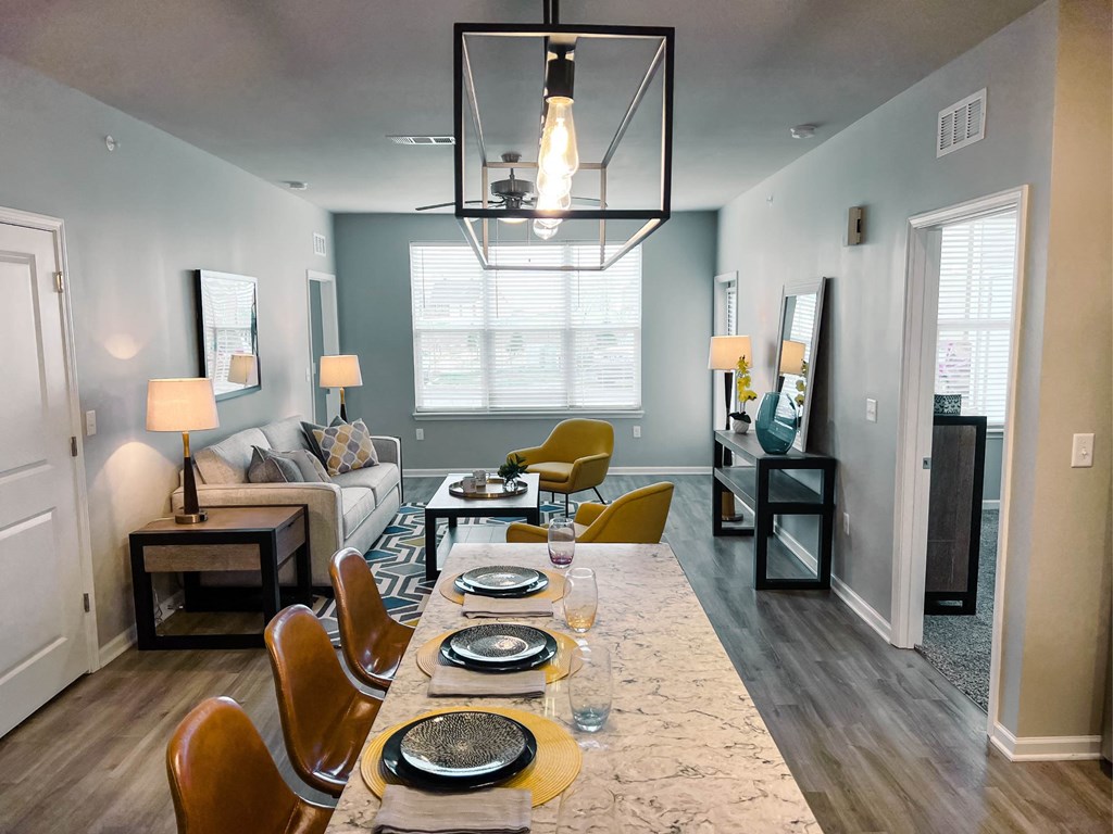 A dining room with a long table set for a meal.