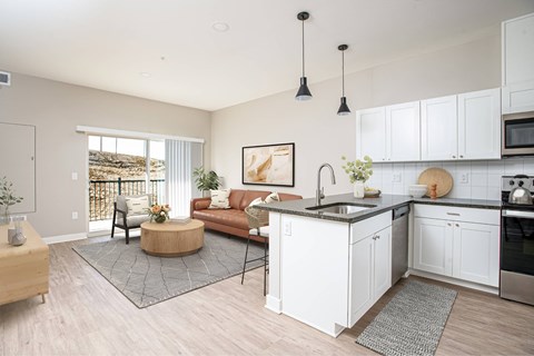 A modern kitchen with white cabinets and a large island.
