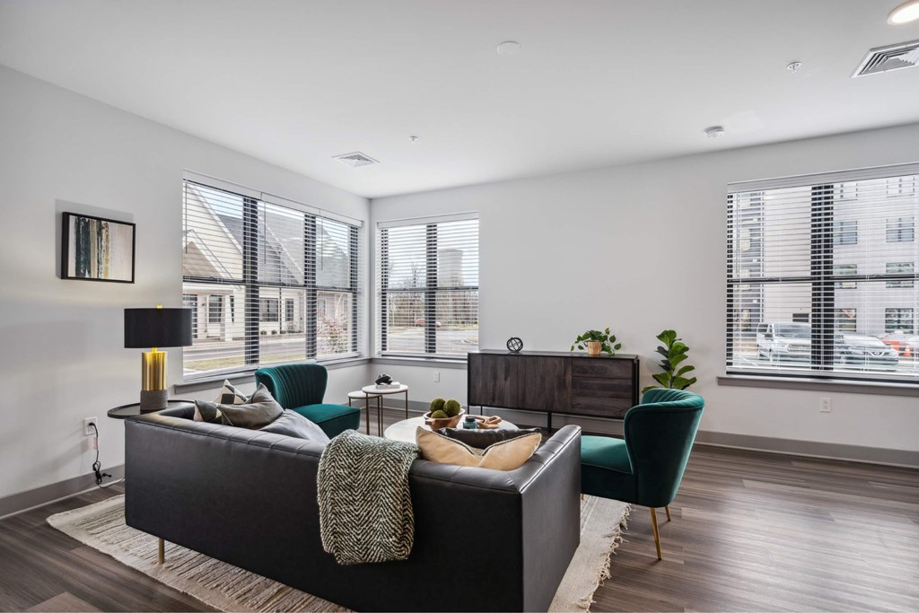 A modern bedroom with a large bed and a green chair.