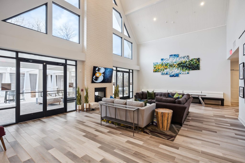 A modern living room with a fireplace and a large painting on the wall.