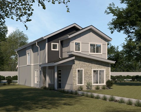 A modern house with a grey and white exterior and a large front yard.