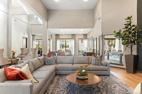 A living room with a grey sofa and a coffee table.