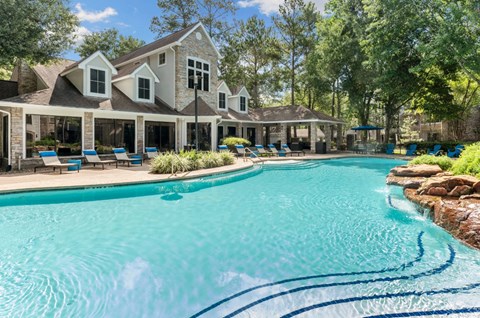 A large house with a pool in front.