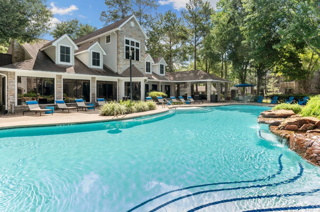 A large house with a pool in front.