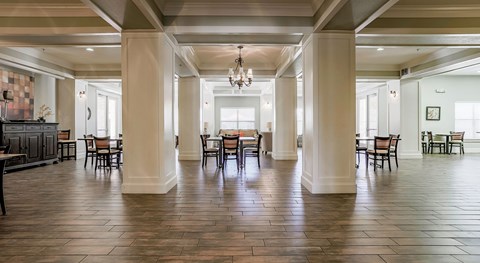 A large room with a long table and chairs.