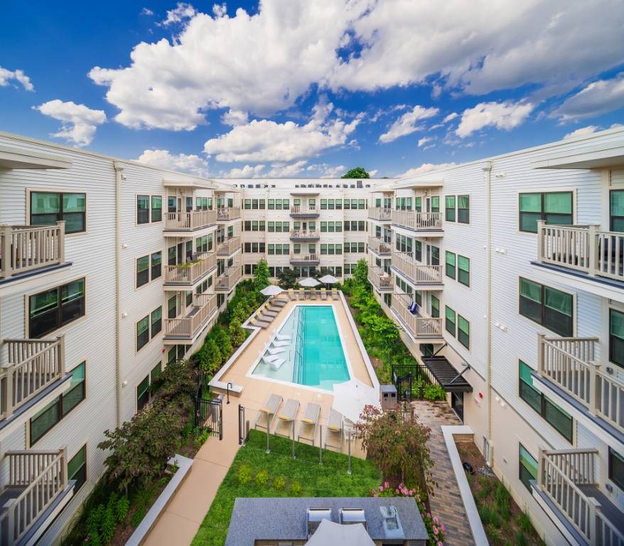 Silver Spring, MD Pet Friendly Apartments - Atelier Apartments - Exterior Shot Of Swimming Pool Surrounded By Lounge Chairs And Umbrellas