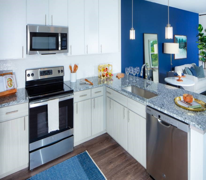 A modern kitchen with a stainless steel oven and microwave.