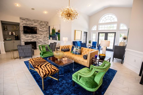 A living room with a zebra print chair and a green chair.
