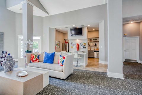 A living room with a white couch and a television.