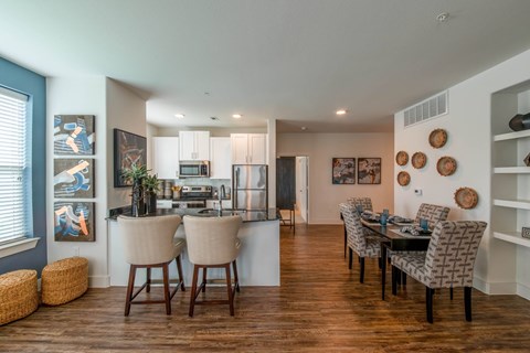 A modern kitchen with a dining table set for four.