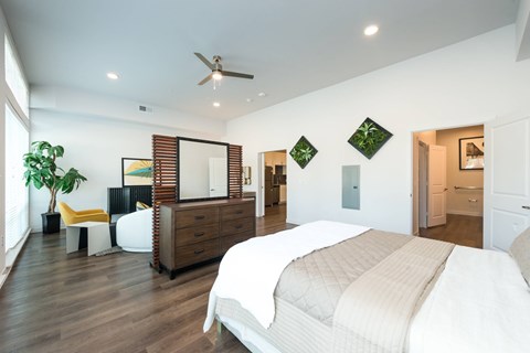 A bedroom with a large bed and a dresser.