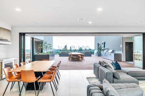 A modern dining room with a long table and chairs.