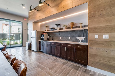 A modern kitchen with wooden cabinets and a large island.