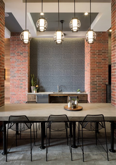 An outdoor dining area with a table and chairs.