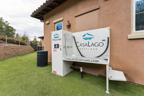 A sign for Casa Lago Eastlake is displayed in front of a house.