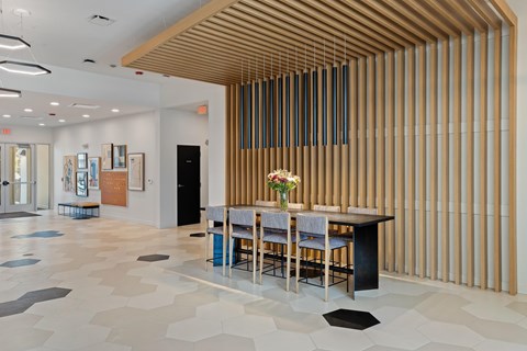 A dining area with a long table and chairs.