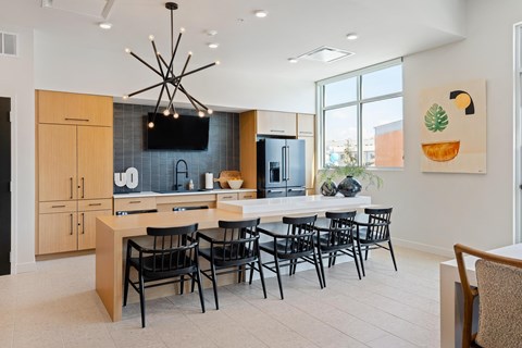 A modern kitchen with a dining table set for six.
