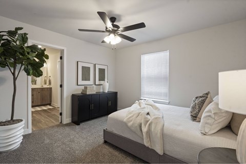 Oak Grove, MO Apartments Near Valley Speedway - Rustic Heights - Image, Ceiling fan, neutral white walls, and plush carpet.