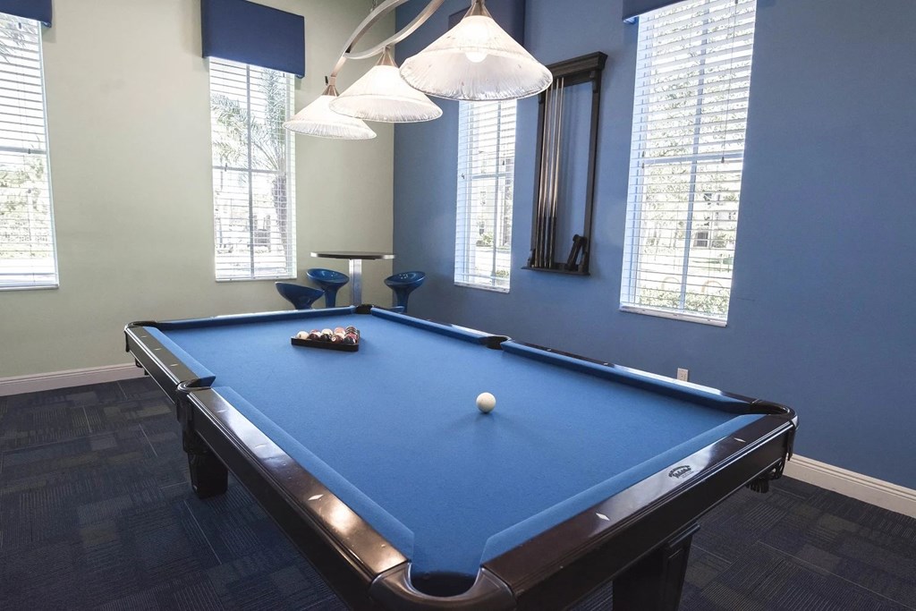 A pool table with a white ball on it.