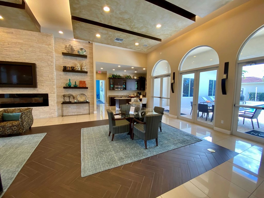 A large, well-lit living room with a dining table and chairs.