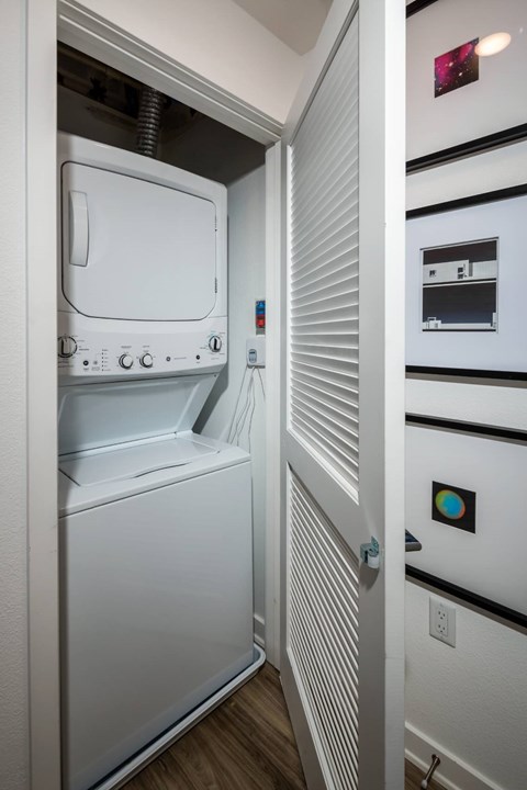 A white oven with a door open is in a kitchen.