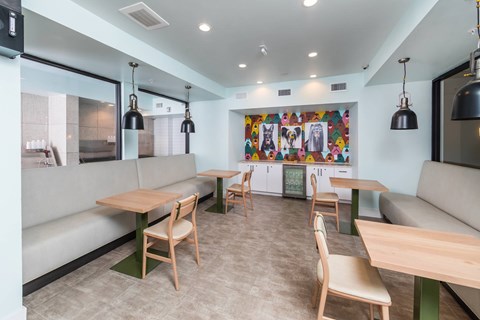 A modern dining area with wooden chairs and tables.