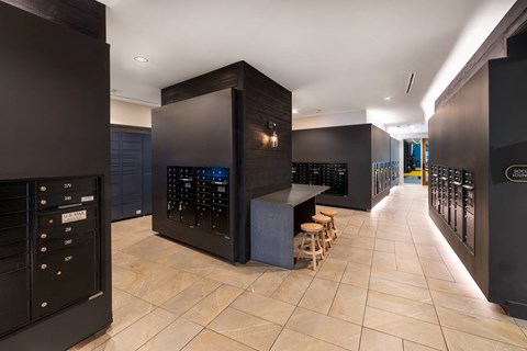 A modern kitchen with black cabinets and a wooden island.