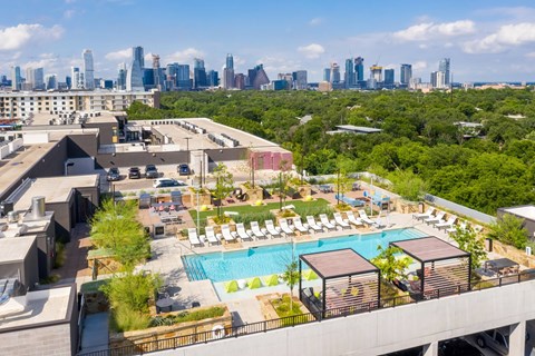 A rooftop pool area with Austin, TX skyline in the background.