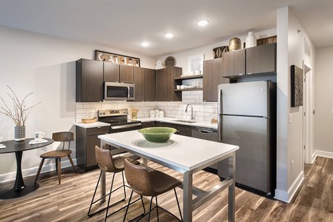 A modern kitchen with a dining table and chairs.