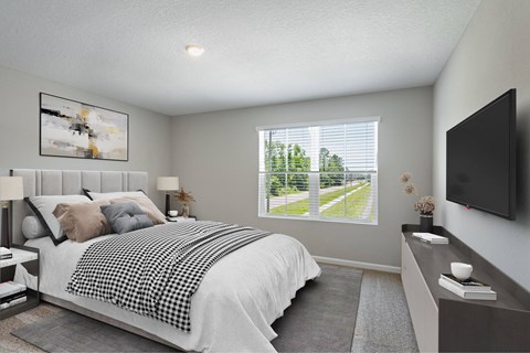 A bedroom with a large bed and a window overlooking a green landscape.