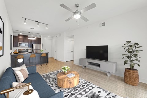 A living room with a blue couch and a television.
