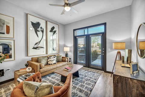 A living room with a brown chair and a brown couch.