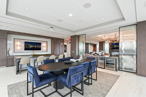A modern dining room with a large table and chairs.
