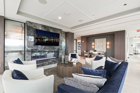 A modern living room with a fireplace and a large painting on the wall.