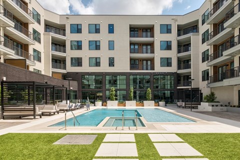 A large building with a pool in front.