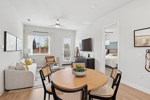 A dining room with a wooden table and chairs.
