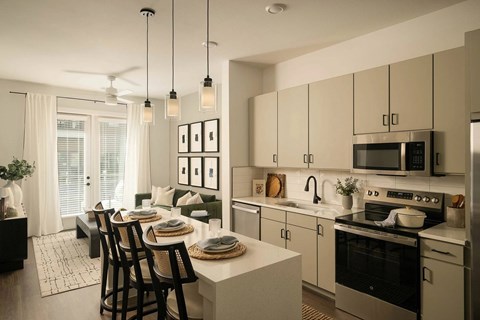 A modern kitchen with a dining table and chairs.