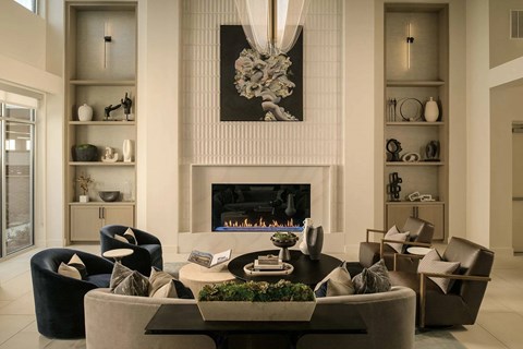A modern living room with a fireplace and a large painting above it.